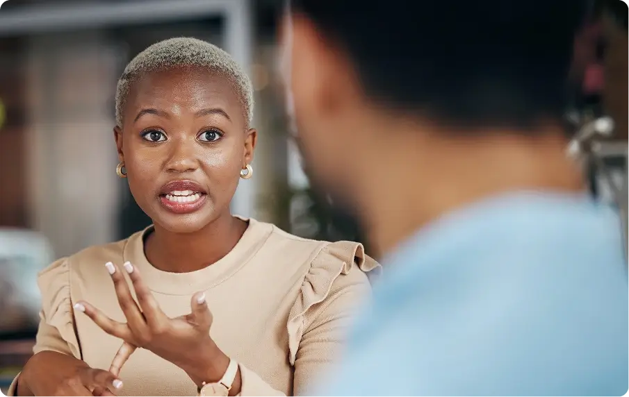 A Black woman speaking, representing a Tender Funding specialist giving advice to a client.